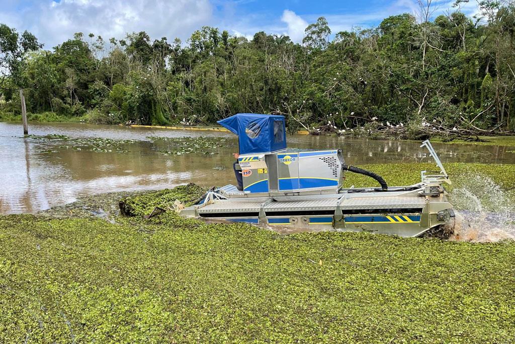 Truxor driving through an infested waterway