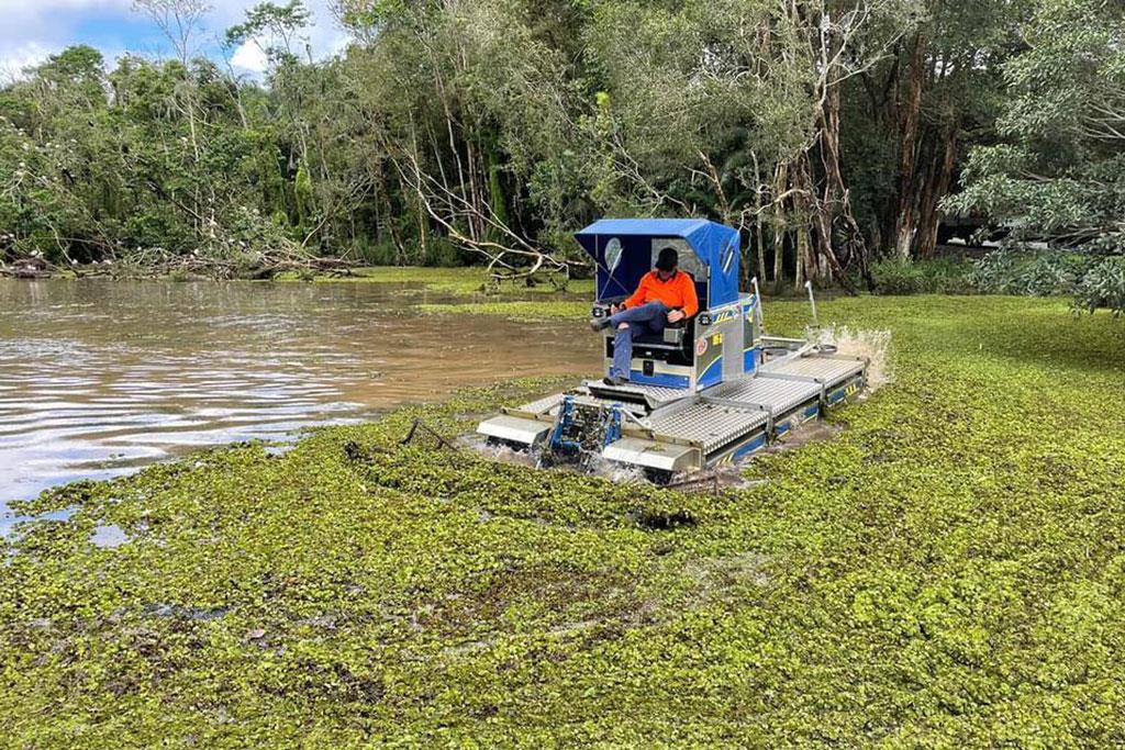 Truxor surrounded by weeds in a waterway